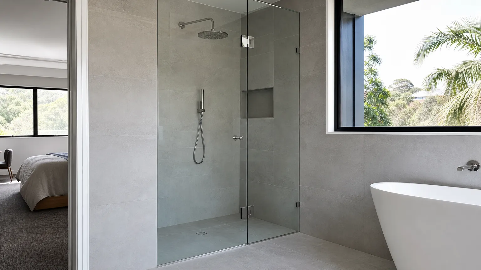 a frameless glass shower screen with a hinged door and chrome fittings